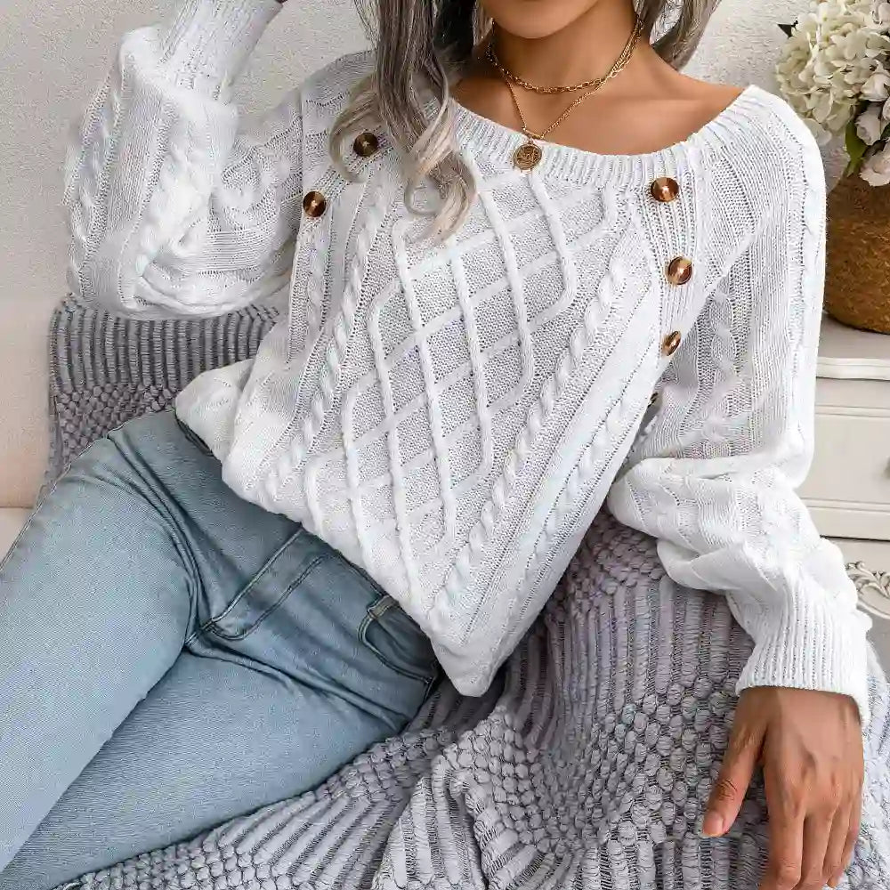 White cable-knit sweater styled with light-wash jeans, chic casual look